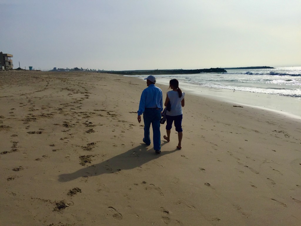 Paul Patel and Salil Patel's mother walking on Ventura Beach